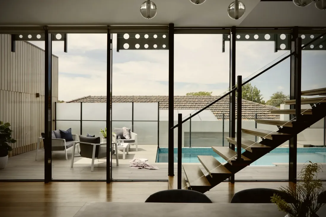 Outdoor terrace furniture beside a pool