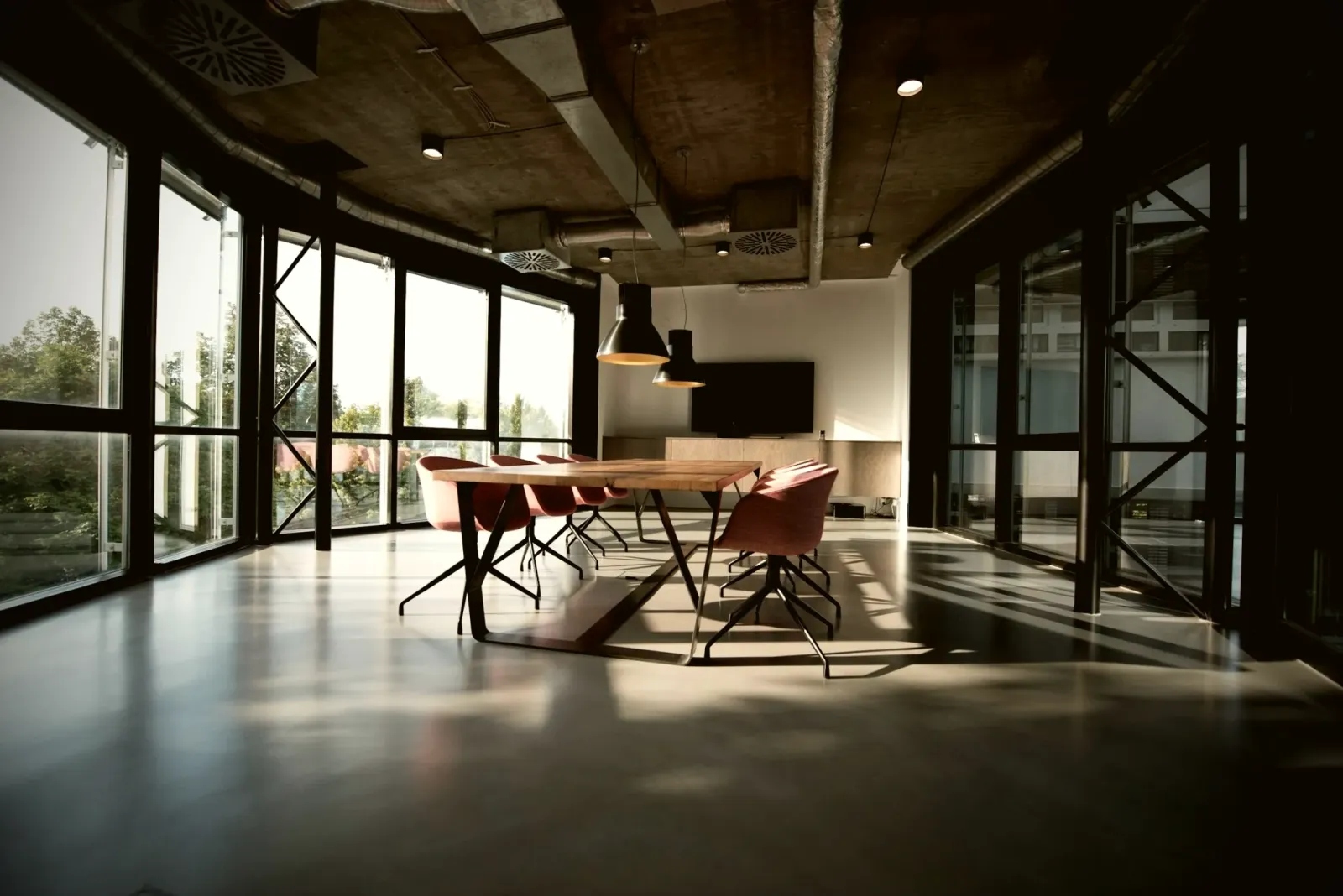 Open-plan office with a meeting table and glass partitions