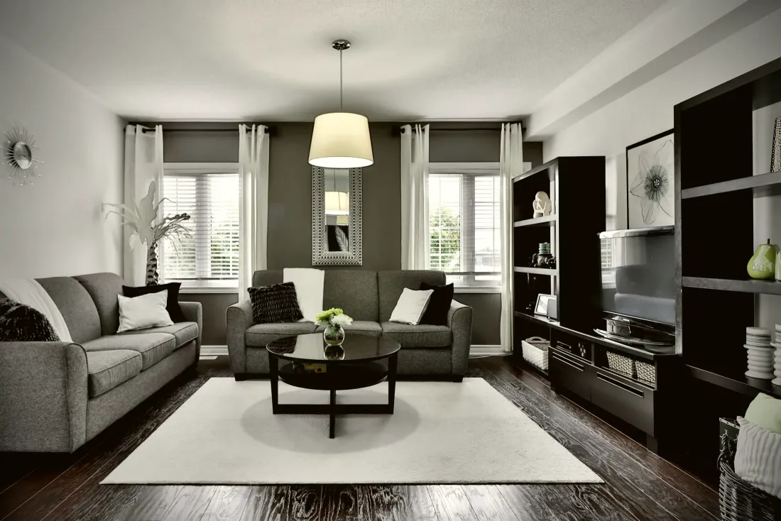 Living room with built-in shelving and a feature wall