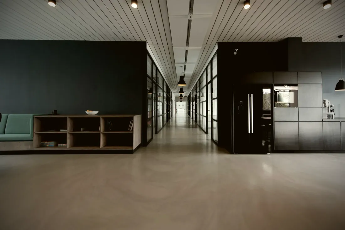 Office corridor with dark walls and fitted storage
